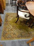 A wool rug with green ground and borders, floral decoration,