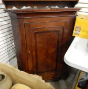 An early 19th century oak and mahogany banded hanging wall cupboard,