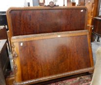 A mid 20th century walnut bed frame, the bed head with carved shell cresting rail,