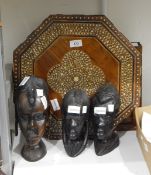 Three African carved hardwood heads together with an Eastern hardwood octagonal top inlaid table