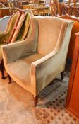 Early twentieth century wing armchair on square tapering legs with castors,