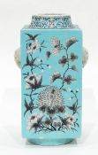 A Chinese vase of square form, decorated with flowers in grey on blue ground,