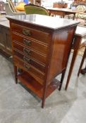 An Edwardian mahogany chest of five drawers, four with sheet music,