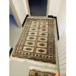 A Chinese wool rug with cream ground and borders, geometric pattern,