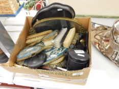 An ebony dressing table set, various hand mirrors, brushes and trays etc.