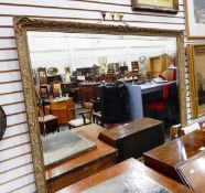 A rectangular bevelled and cut wall mirror within moulded frame,