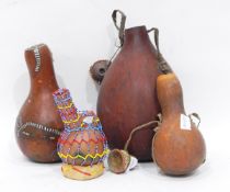 A quantity of African gourd vessels, vases, instruments and similar,