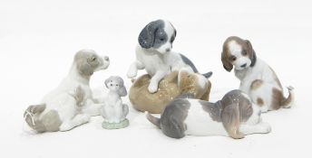 A collection of five Lladro/Nao dogs: 'Twer & Mikie' (puppy dogs playing), Resting Dog,