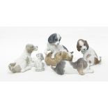 A collection of five Lladro/Nao dogs: 'Twer & Mikie' (puppy dogs playing), Resting Dog,