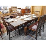 A circa 1930's oak draw-leaf dining table on stout bulbous turned supports and with X-stretchers