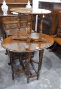 An oval oak drop-leaf gateleg table with spiral turned supports,