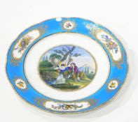 A continental porcelain plate, the central scene depicting a shepherd and his maid by a waterfall,