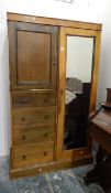 A stained pine single hanging wardrobe with two short and three long drawers,