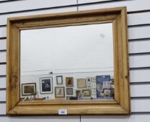 A rectangular wall mirror in moulded pine frame