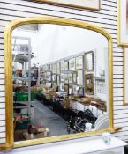 An overmantel mirror of rectangular form with arched top, in moulded gilt frame,