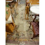 A Chinese wool rug with cream ground, brown borders, geometric pattern,