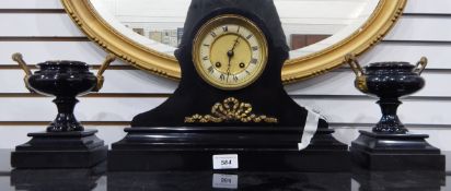 A Victorian black slate clock garniture, the drum-shaped movement in waisted case, on plinth base,