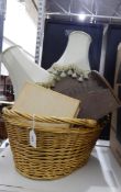 A large two-handled shopping basket, a wooden letter rack, two table lamps, a book, etc.