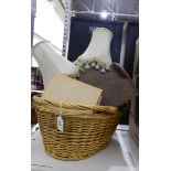 A large two-handled shopping basket, a wooden letter rack, two table lamps, a book, etc.