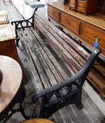 A slat back Coalbrookdale-style cast iron garden bench