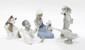 A Lladro group of a young girl seated with a puppy and kitten,