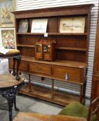 An oak Welsh dresser with three frieze drawers and open under-shelf supported by circular tapered