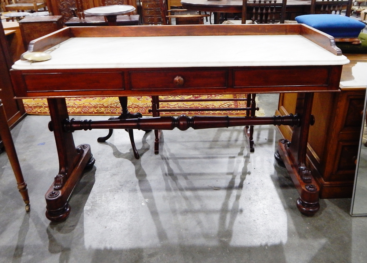 A Victorian marble top washstand having three-quarter gallery, the stand with turned pole stretcher,