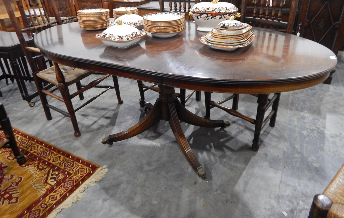 A oval mahogany extending pedestal dining table,