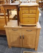 A modern side cabinet with two short drawers and cupboard under, on square block supports,
