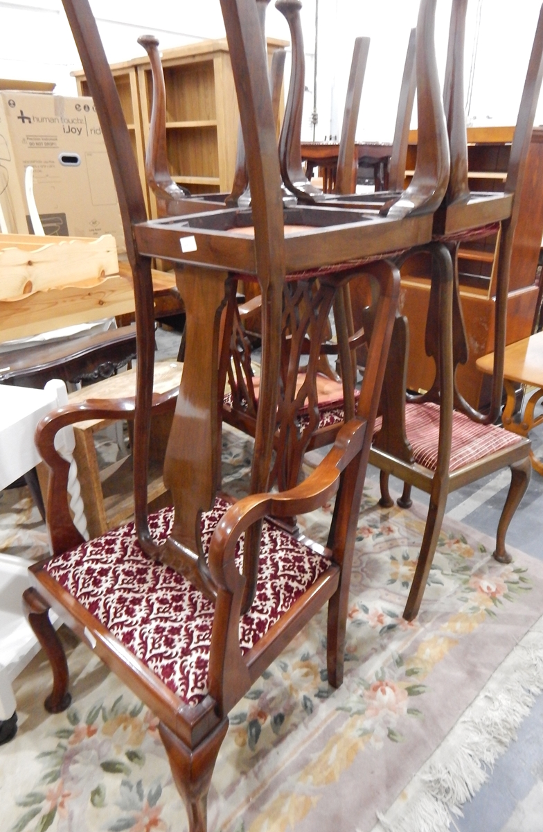 A set of four mahogany Queen Anne style dining chairs with vase splats and cabriole supports