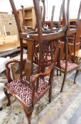 A set of four mahogany Queen Anne style dining chairs with vase splats and cabriole supports