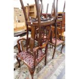 A set of four mahogany Queen Anne style dining chairs with vase splats and cabriole supports