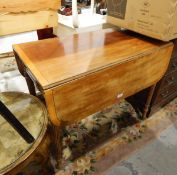 A late Regency mahogany Pembroke table fitted a drawer to frieze with lion mask and ring handles