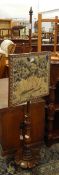 A nineteenth century rosewood pole screen with needlework panel,