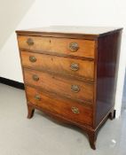 An early 20th century mahogany chest of four graduated drawers, on shaped bracket feet,
