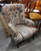 A wing back armchair re-upholstered in geometric patterned fabric,