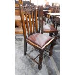 A set of six oak framed slat back dining chairs viz:- four standards and two carvers