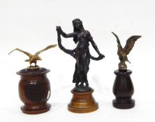 A bronzed-effect figure of a dancing classical maiden raised on plinth together with two eagles on