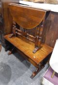 An oak drop-leaf gateleg Sutherland type table and an oak magazine table on turned and carved