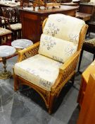 A pair of cane back conservatory chairs with floral cushions (2)