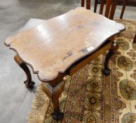 A Georgian style walnut rectangular top side table, with wavy edge, frieze drawer,