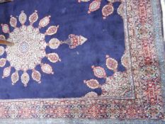 A Persian style wool rug having blue ground and red borders, floral and geometric pattern,