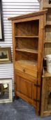 A modern hardwood corner unit with three open shelves,