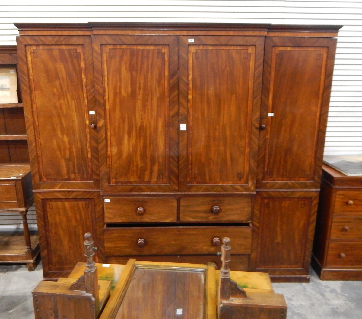 A Victorian breakfront mahogany compactum, comprising central cupboard with sliding linen trays,