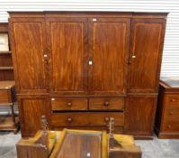 A Victorian breakfront mahogany compactum, comprising central cupboard with sliding linen trays,