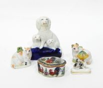 A Staffordshire group of spaniels, a pair of Staffordshire models of sheep,