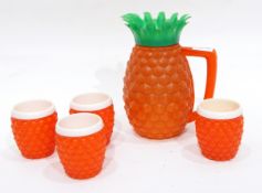 A pineapple shaped jug with four matching cups together with a black lacquer jewellery cabinet in