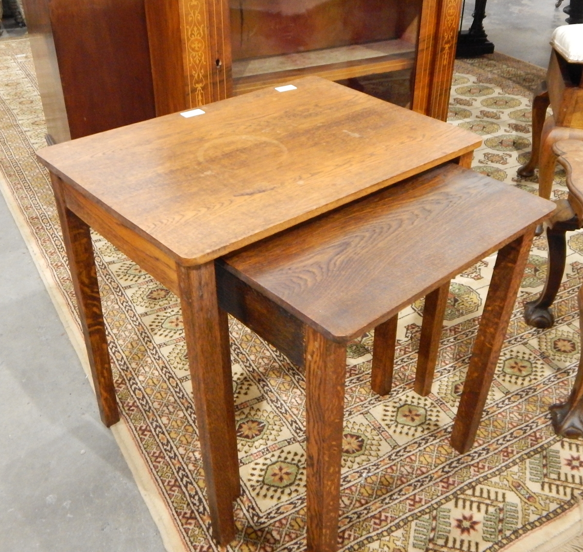 A 20th century oak nest of two tables on square tapering legs,
