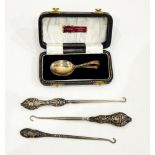 Three button hooks with silver handles, a pair of Victorian silver plated serving spoons,