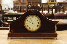 A 20th century mahogany timepiece having scroll carved arched top,